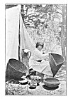 A BASKET MAKER.<BR>
She is weaving a burden basket. The one to the left is for cooking, and a baby basket stands against the tent.